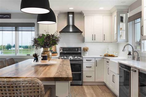 steel appliances black countertop white cabinets and yellow walls kitchen|white countertops with white appliances.